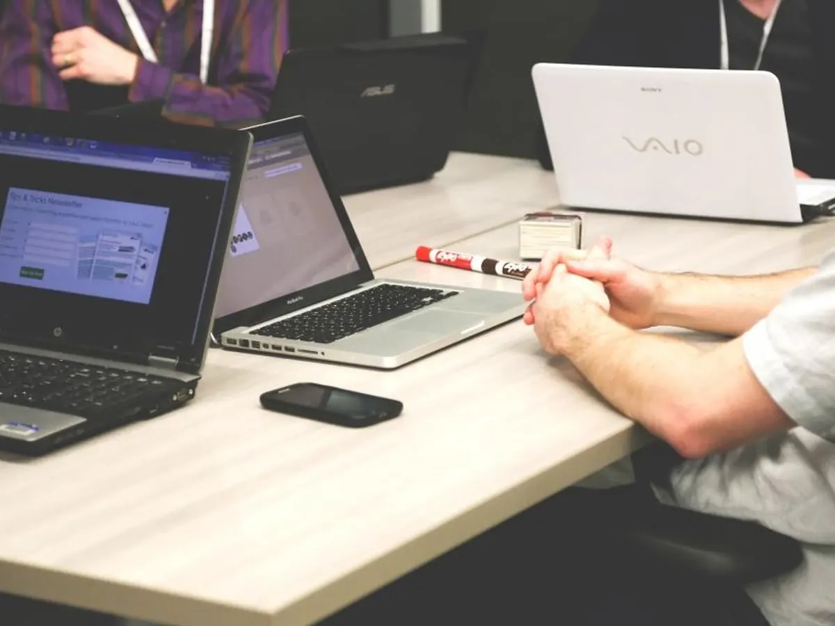Students learning on laptops in a training session